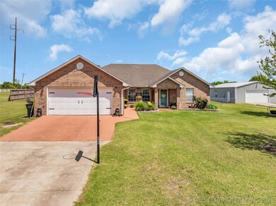 View of front facade with concrete driveway, brick