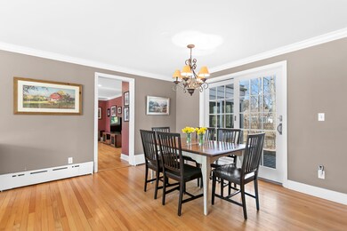 Dining room with hardwood floors, leads to kitchen
