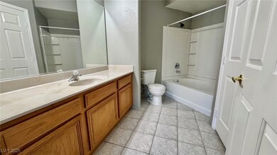Bathroom featuring vanity, tile patterned flooring