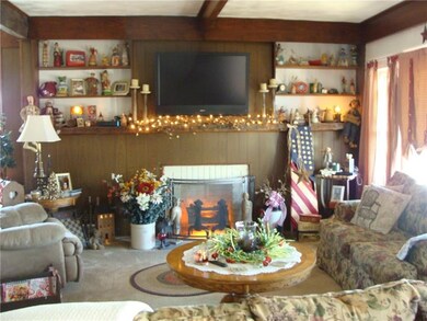 LIVING ROOM HAS DECORATIVE FIREPLACE AND BUILTIN B