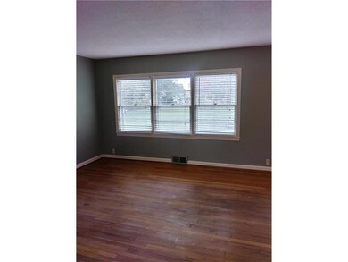 Living room wall of windows overlooking park like 