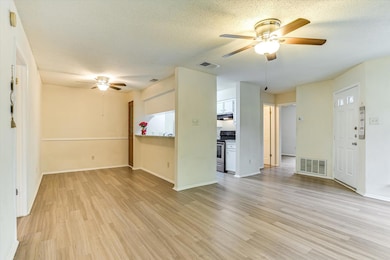 Unfurnished living room featuring a ceiling fan, 