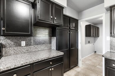 Kitchen featuring light stone countertops, tastefu