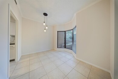 Light-filled dining area featuring large bay windows, tile flooring, and modern pendant lighting.