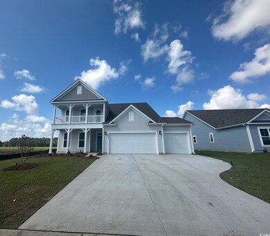 View of front of house with a balcony, a garage, a