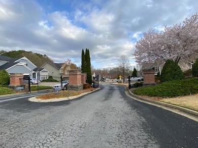 View of street featuring a gate, a gated entry, cu