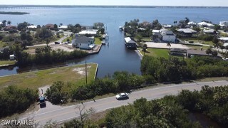 Birds eye view of property with a water view