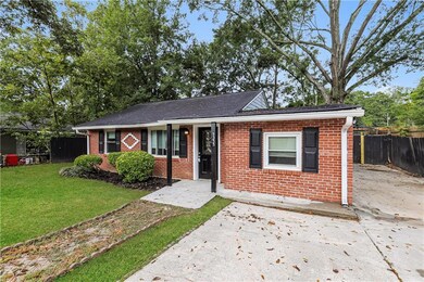 View of front of house with brick siding and roof with shingles