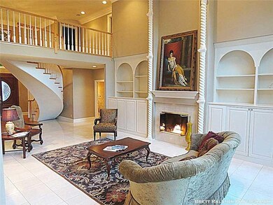 Living Room. Spacious living room with built in cabinetry, gas log fireplace and arched windows!