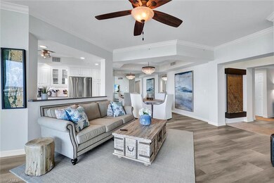 Living room featuring ceiling fan, crown molding, 