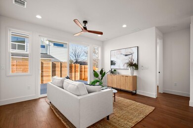 Living area with recessed lighting, visible vents