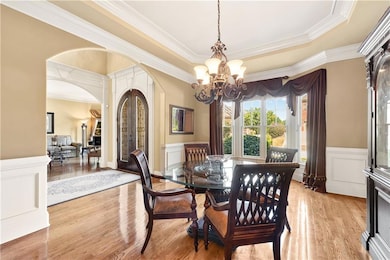 The expansive dining room offers ample space for hosting large dinner parties, featuring refined architectural details and a sophisticated atmosphere