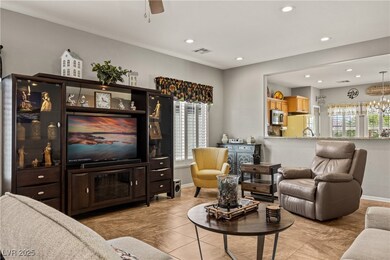 Living room with baseboards, ceiling fan with nota