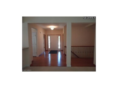 The wood foyer and hallway and also the stairwell 