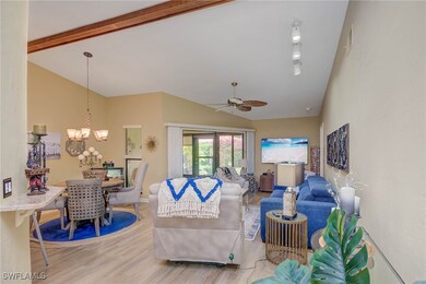Living room with wood finished floors, a chandelie