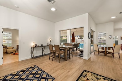 Dining room with light wood-type flooring and recessed lighting