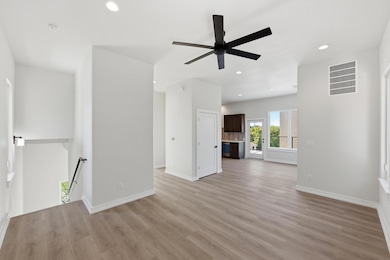 Unfurnished living room with light wood-style floors, recessed lighting, and ceiling fan