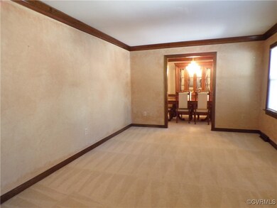 Formal living room featuring light colored carpet