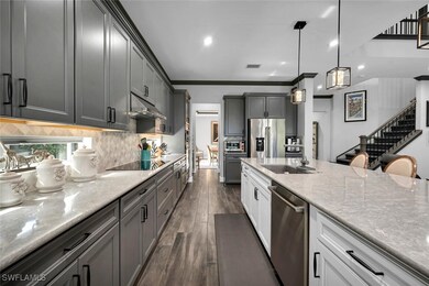 Kitchen featuring stainless steel appliances, dark