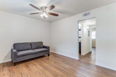 Sitting room featuring a ceiling fan, wood finish
