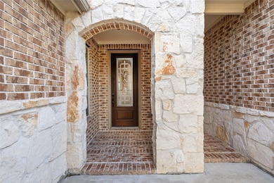 The welcoming entryway with a combination of brick