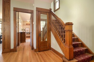 Classic entry, pretty staircase and mirrored entry door