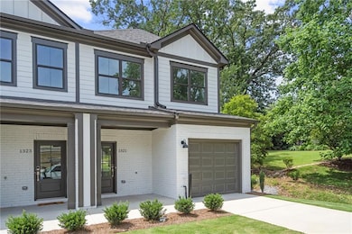 View of front of home with a porch and a garage
