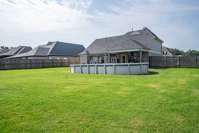 Back of house with ceiling fan, brick siding, and roof with shingles