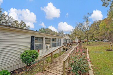 Wooden deck featuring a yard and cooling unit