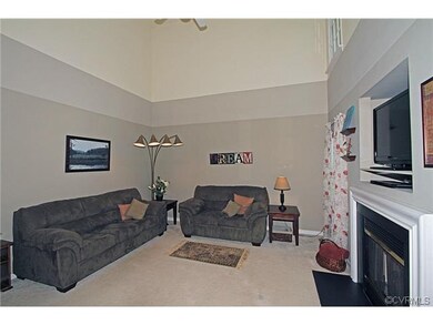 The two story family room has ceiling fan and gas 