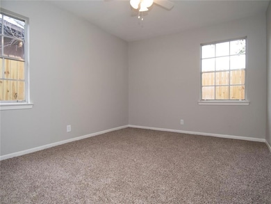 Unfurnished room with light carpet and ceiling fan