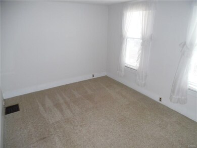 This living room is bright with  clean newer carpe
