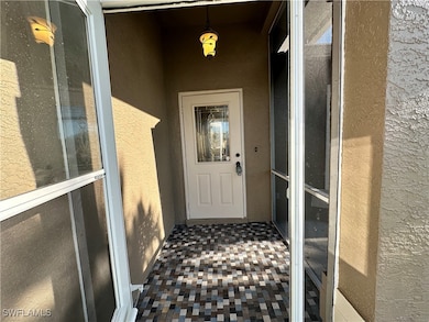View of exterior entry featuring stucco siding