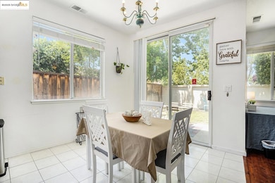 Dining room featuring a chandelier and light tile patterned floors
