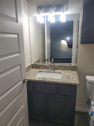 Half bath featuring vanity and toilet