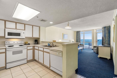 Kitchen featuring light countertops, a sink, white