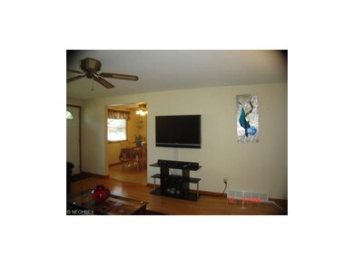 Fourth view of living room into kitchen.