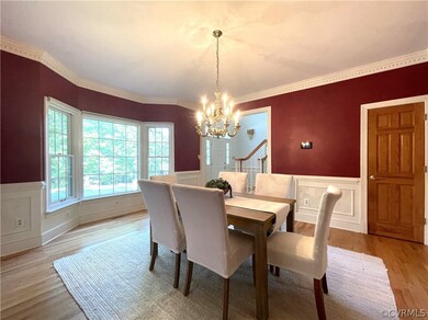 Dining room featuring ornamental molding, light wo