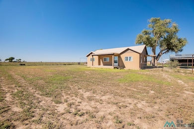 View of yard featuring a rural view and covered porch