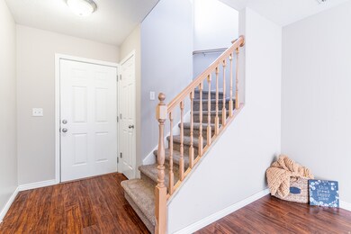 Foyer entrance featuring dark wood-style floors and stairs