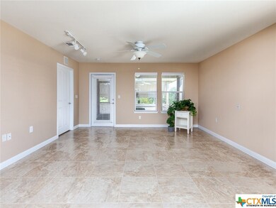 View of the great room from the front door. The door on the left leads to the master and the door directly ahead leads to the porches.