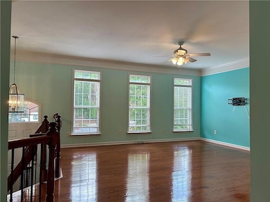 Unfurnished room with ceiling fan with notable cha