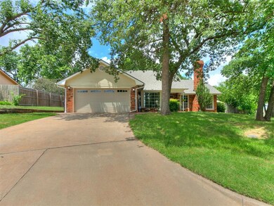 Ranch-style house with a chimney, an attached garage, brick siding, and driveway