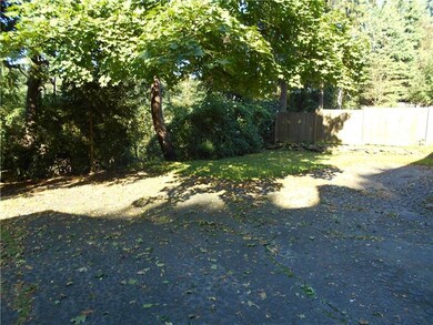 Spacious back yard adjoins a wooded area, and ther