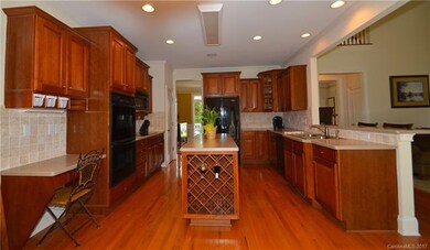 Double ovens, tumbled stone backsplash, and beauti