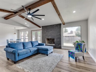 Living room with a tile fireplace, vaulted ceiling
