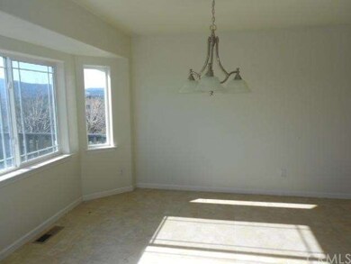 dining area off kitchen with big windows