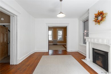 Hardwood floored entrance foyer with radiator and