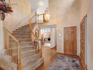 Foyer featuring a towering ceiling, baseboards, an
