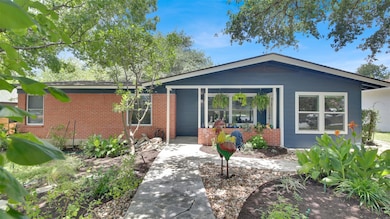 Single story home with brick siding